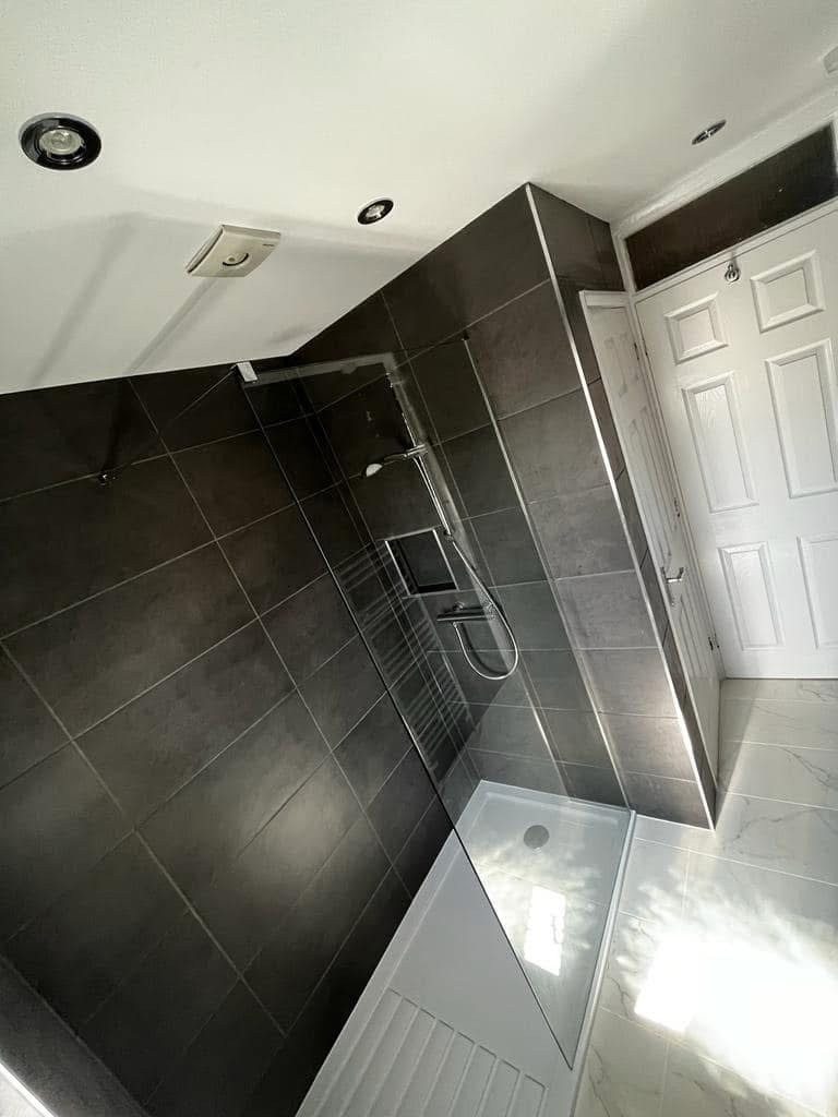 New walk-in shower with glass screen, chrome fittings and modern detailing
