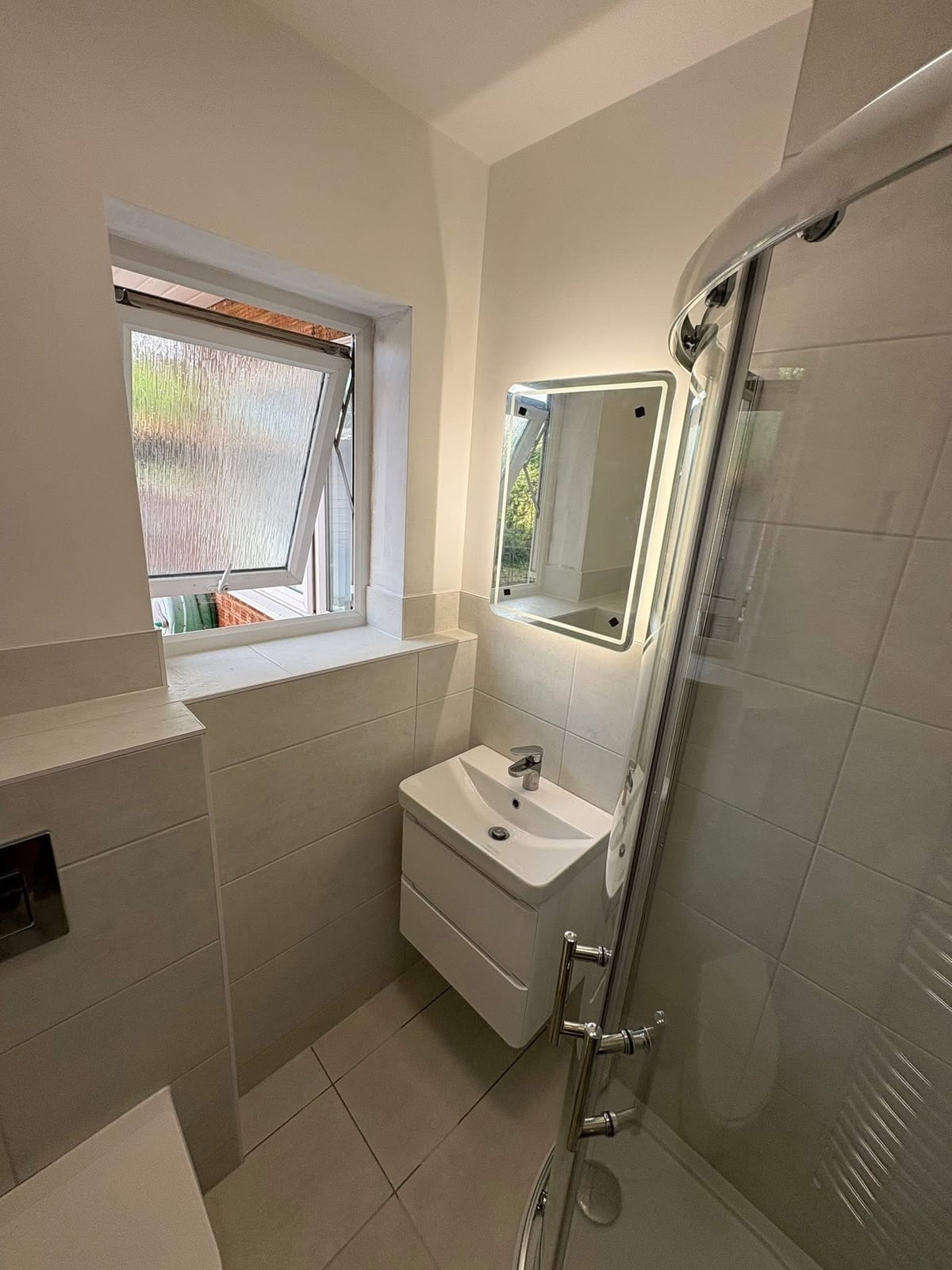 New wall-hung sink, mirror and walk-in shower with glass screen