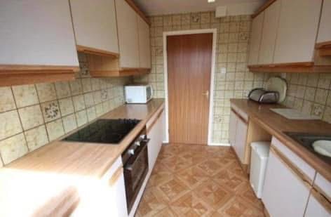 Old galley kitchen showing the cooker and original layout