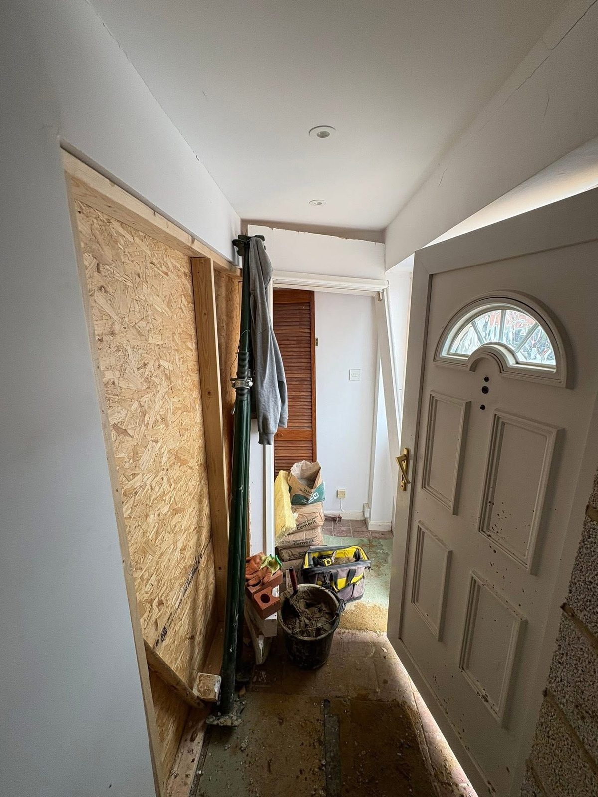 Interior of the property during initial works, with the damaged area boarded up and supported
